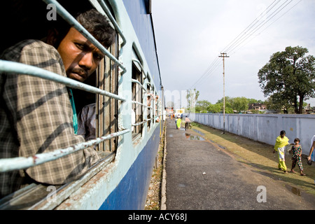 Man looking through the window. Train Gorakhpur to Varanasi. Uttar Pradesh. India Stock Photo