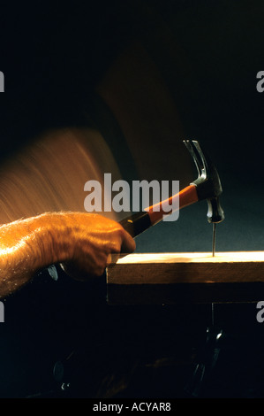 A hammer hitting a nail. Stock Photo