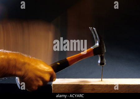A hammer hitting a nail. Stock Photo