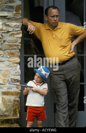 young boy with toy rifle father son waiting Stock Photo