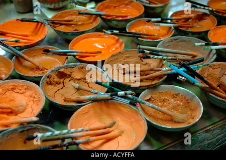 Dishes of terracotta coloured slip for use in factory making miniature terracotta warriors. Xian, China. Stock Photo