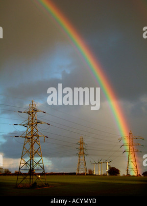 rainbow over electricity pylons Stock Photo