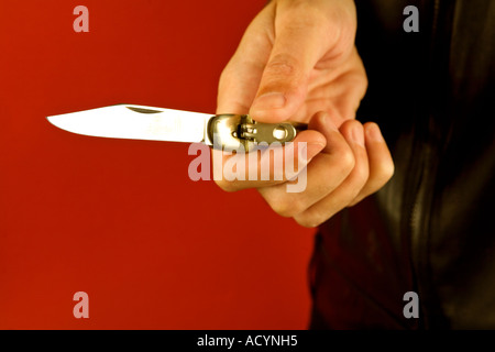 Man holding a flicknife Stock Photo