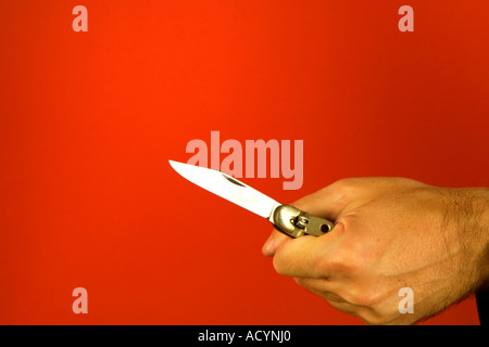 Man holding a flicknife Stock Photo