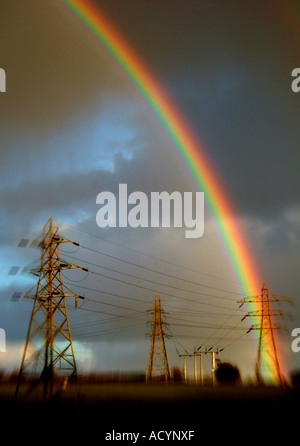 Rain bow over electricity Pylons Hales Norfolk England Stock Photo