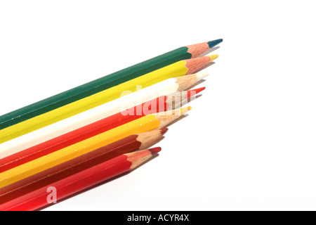 A row of sharpened colored pencils in red, yellow, green, and white arranged diagonally on a white background. Stock Photo