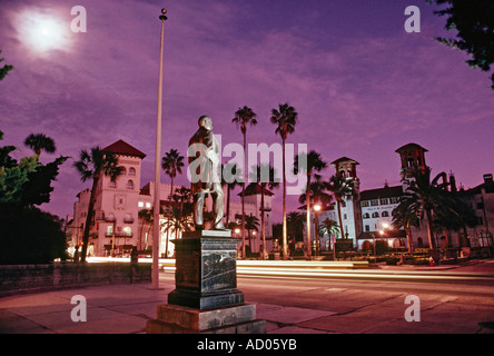 View at night of statue of Henry Flagler and historic Flagler era buildings in St Augustine Florida USA Stock Photo