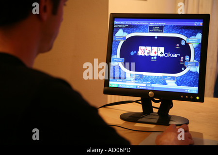 young man playing poker online Stock Photo
