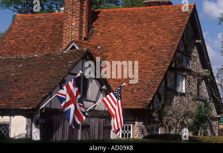 Two allies: British and American flags hung side by side on timber framed cottage in support of Iraq war, Leigh, Surrey, England Stock Photo