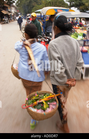 Women Vendors Walking Along At Market Stock Photo