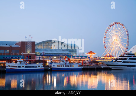 CHICAGO Illinois Water taxis and boats docked at Navy Pier ferris wheel and amusement rides pavilion reflections in water Stock Photo