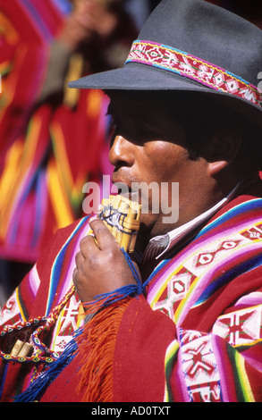 Quechua man from Charazani / Cordillera Apolobamba region to north of La Paz playing panpipes, Bolivia Stock Photo
