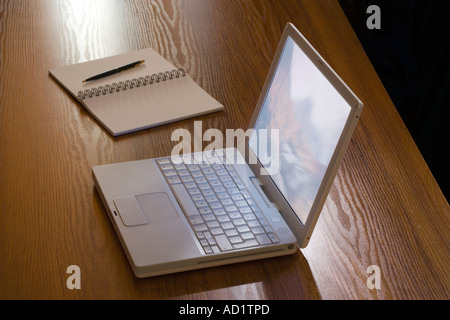 Laptop and notebook on desk Stock Photo