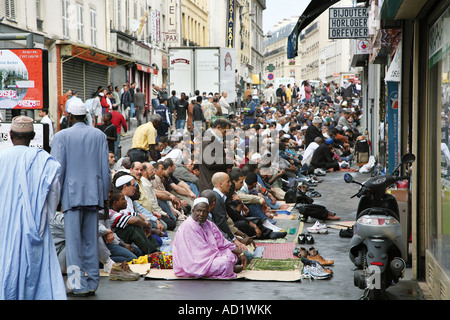 Muslims pray out the Mosque in the Barbès Rochechouart district of Paris. Stock Photo