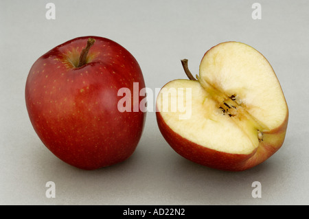 HMA71715 One red Apple full one half cut with gray background Stock Photo