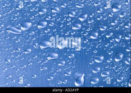 Blue brushed steel with water droplets on Stock Photo