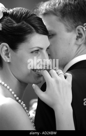 A newly married bride and groom cuddle up on their wedding day Stock