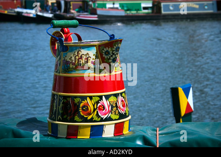 a traditional painted jug sitting on top of a barge on a canal Stock Photo