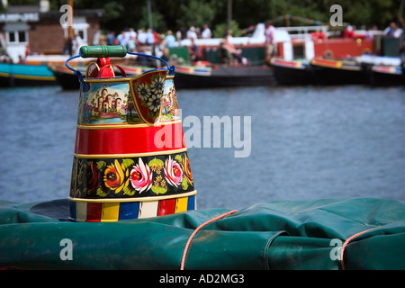 a traditional painted jug sitting on top of a barge on a canal Stock Photo