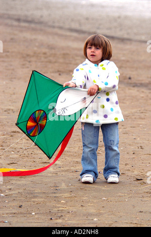 A pre-K female child holding a kite Stock Photo