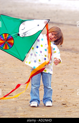 A pre-K female child holding a kite Stock Photo