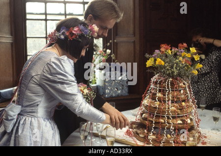 Wedding couple cutting the wedding cake at their reception. Stock Photo