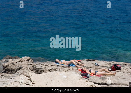 Sunbathing on the rocks on the Island of Lokrum Stock Photo