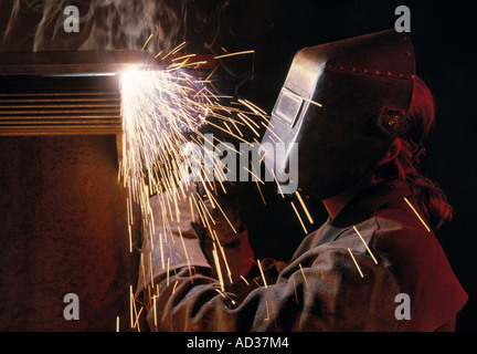 Man welding in mask on construction site. Stock Photo