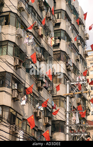 Red flags are hung outside a Shanghai apartment block to celebrate National Day in China Stock Photo