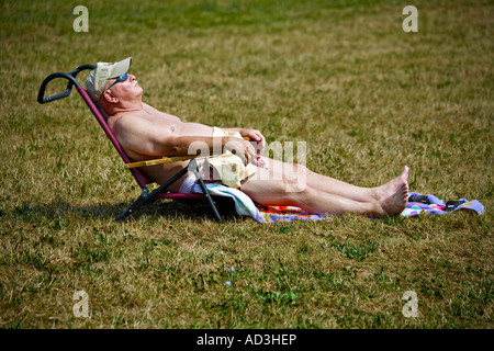 Elderly man relaxing on the grass Stock Photo