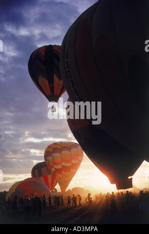 Balloons lifting off at sunrise in Albuquerque Stock Photo