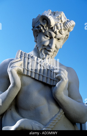 STATUE OF PAN, THE GREEK GOD OF SHEPHERDS, FLOCKS AND WOODLANDS AGAINST A BLUE SKY. JULY. Stock Photo
