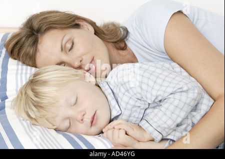 Mother and son sleeping in bed