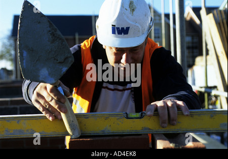 Brick layer at work on a housing development in Ipswich town centre, Suffolk, UK. Stock Photo