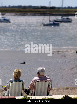 Couple Relaxing by the river Crouch Burnham on Crouch Stock Photo