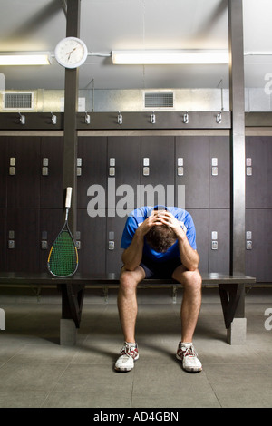A man resting in a locker room Stock Photo