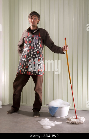 A man standing with a mop and bucket Stock Photo