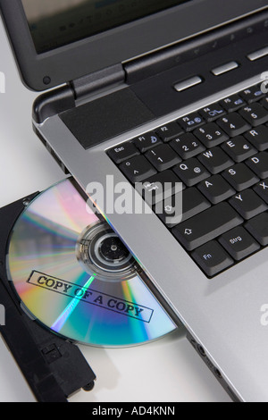 Copied CD in the disc drive of a laptop computer Stock Photo