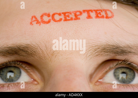 A man with 'Accepted' stamped on his forehead Stock Photo