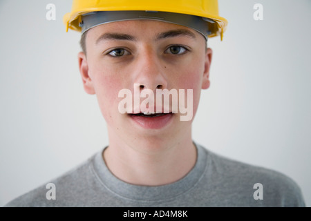 Teenage boy wearing a hard hat Stock Photo