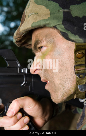 Soldier aiming his gun Stock Photo