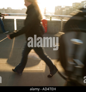 Going to work early morning walk over London Bridge 2007 No model release required as face cropped blurred flared recognizable Stock Photo