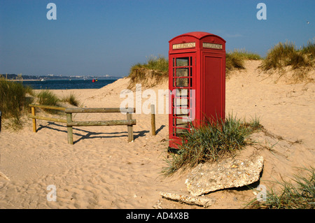 Traditional K6 English telephone box on yellow sandy beach at Sandbanks in Dorset Stock Photo