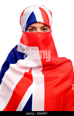 Muslim woman wearing a union jack flag as a  hijab burka with a white background Stock Photo