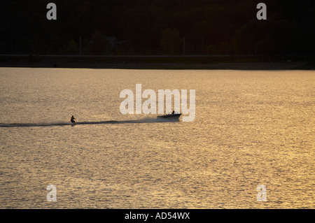 Watersking behind boat at sunset in Hinckley Reservoir in Herkimer County New York Stock Photo