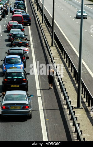 Closed motorway due to an accident with bored motorist caught up in a long tailback people pollution climate change Stock Photo