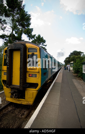 Diesel Multiple Unit DMU train at the remote welsh rural railway station on the Cambrian Line, Caersws Powys Mid Wales UK Stock Photo