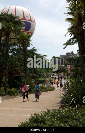 Two young women, mother and child, daughter, strolling through Bournemouth Pleasure Gardens, Dorset, England, UK in the summer Stock Photo