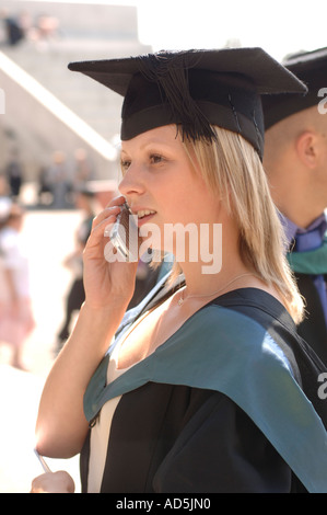 Female Graduate of Aberystwyth University with mortar board talking on mobile phone, Graduation Day, Wales UK Stock Photo