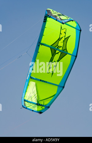 Vertical view of the brightly coloured canopy of a kite surfer against a blue sky Stock Photo
